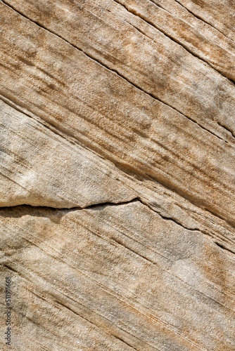 Sheer cliff of cracked sandstone close-up. Texture and pattern of natural stone