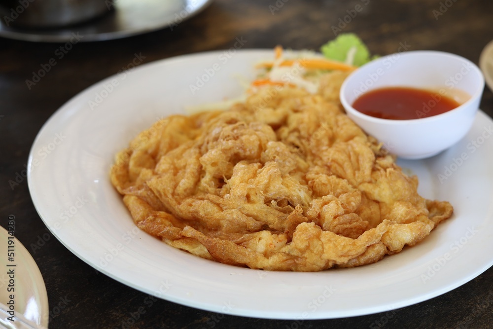 Delicious omelet on plate with tomato sauce Delicious omelet on plate with tomato sauce