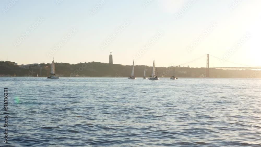 Shot of small yachts on calm water with a bridge in the background. Shot of small yachts on calm water with a bridge in the background.