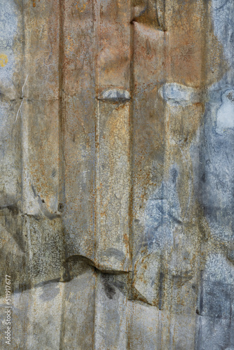 Old metallic wall with peeling paint.
