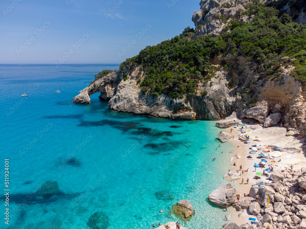 Cala Goloritze beach with crystal clear waters seen from the drone, Sardinia, Italy