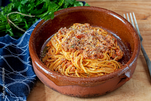 A terracotta bowl with spaghetti 