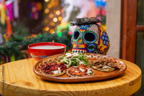 Photography Traditional Mexican dia de muertos offering with sopes of meat and pulque