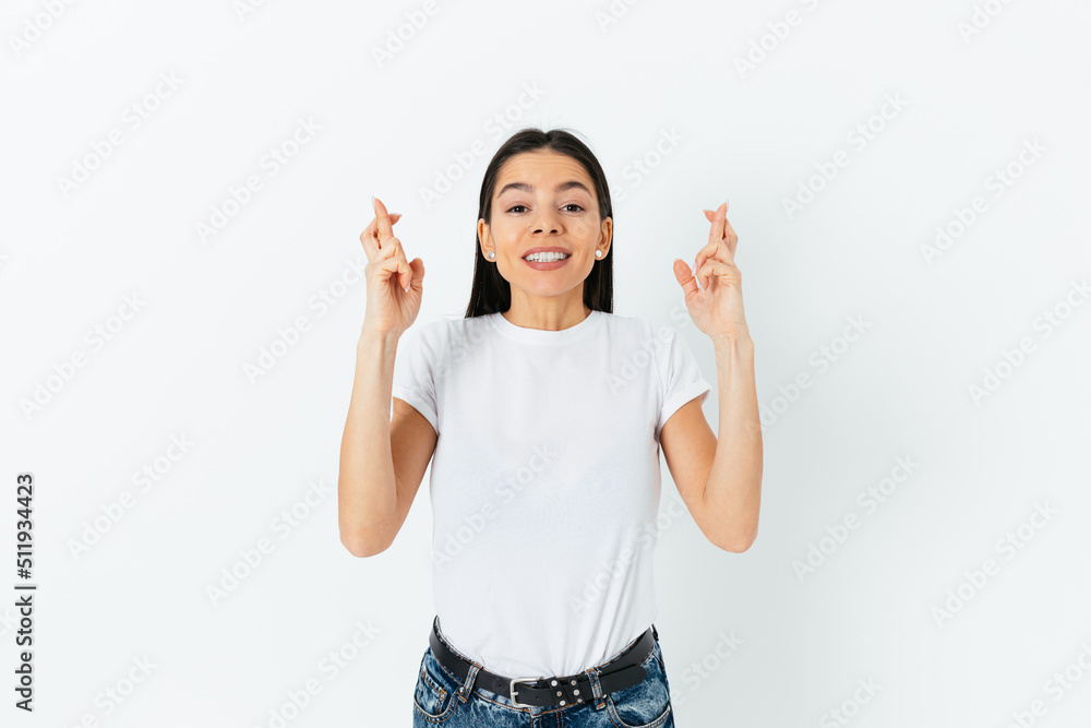 Portrait of hopeful young woman crossing her fingers makes wish Portrait of hopeful young woman crossing her fingers makes wish
