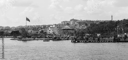 Avcilar port view with small boats and Turkish flag. Black and white photo