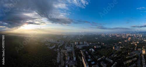 Peaceful sunrise cloudscape panorama view in green city residential district. Aerial Pavlovo Pole, Kharkiv Ukraine. Morning skyscape, cloudscape and streets