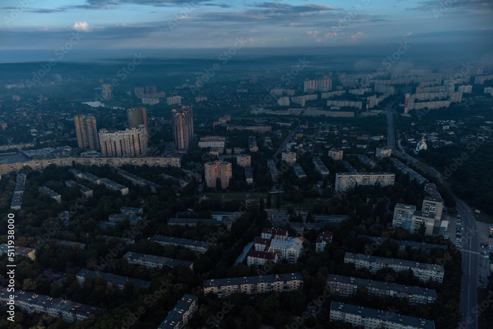 Blue morning cloudy view in summer city residential district. Aerial cityscape above buildings and streets, Kharkiv Ukraine