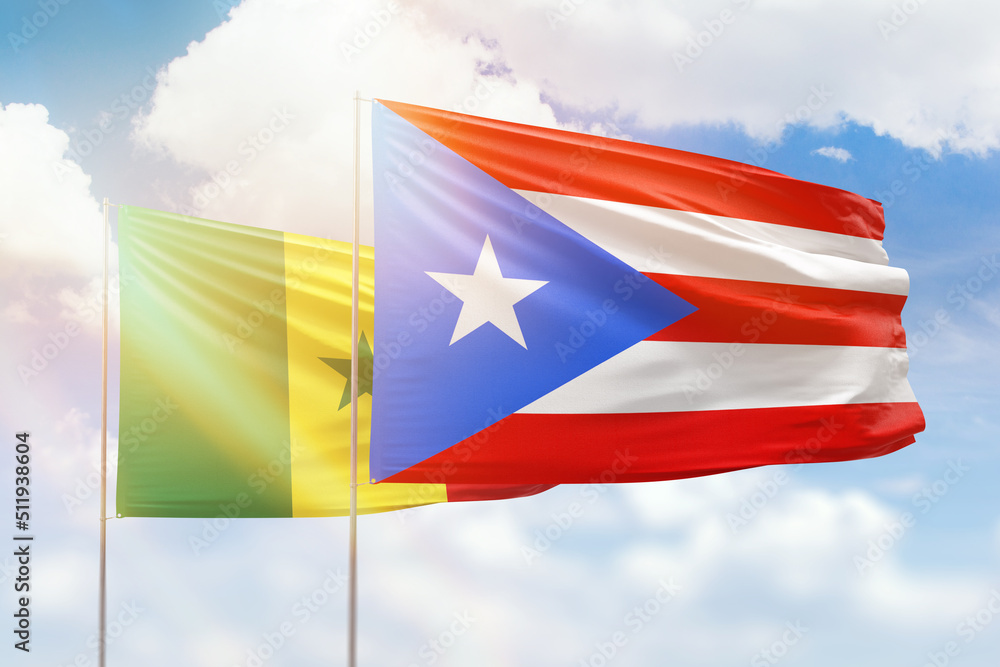 Sunny blue sky and flags of puerto rico and senegal Sunny blue sky and flags of puerto rico and senegal