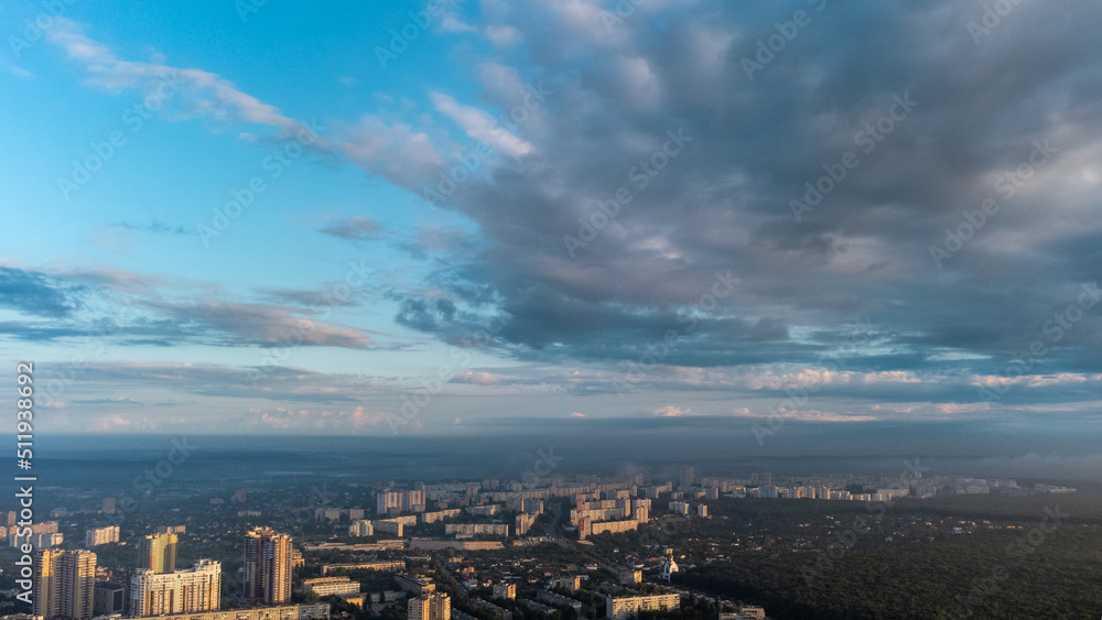 Blue morning epic cloudy skyscape in summer city residential district. Aerial view above buildings and streets, Kharkiv Ukraine