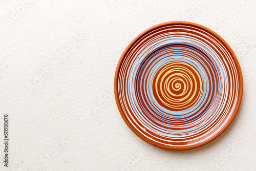 Top view of empty colorful plate on cement background. Empty space for your design