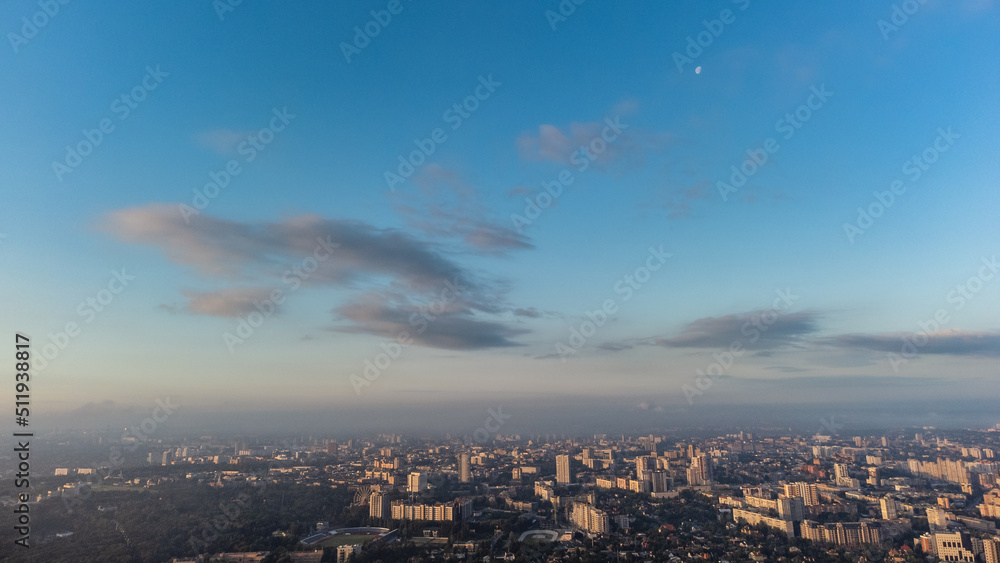 Blue morning skyscape view in summer sunny city residential district. Aerial cityscape above buildings and streets, Kharkiv Ukraine