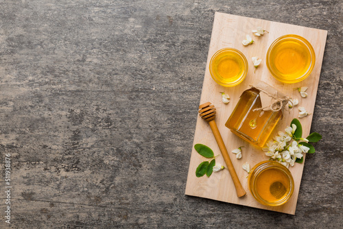 honey jar with acacia flowers and leaves. fresh honey top view flat lay