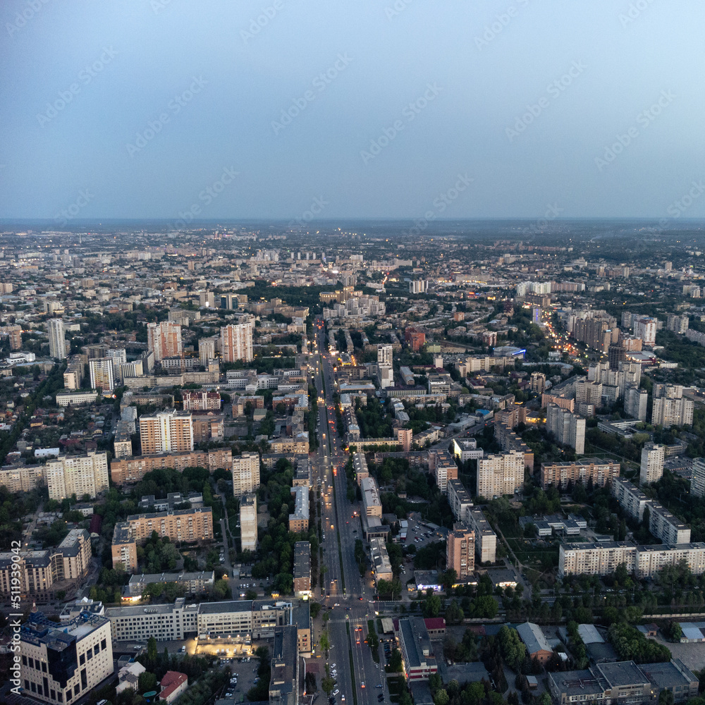Aerial view Kharkiv city center Nauky avenue. Pavlove Pole and Central area with multistory high residential buildings in evening with street lights illumination