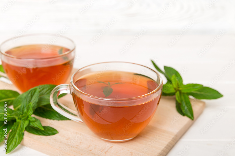 Cup of mint tea on table background. Green tea with fresh mint top view with copy space Cup of mint tea on table background. Green tea with fresh mint top view with copy space