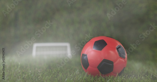 Red soccer ball in fog