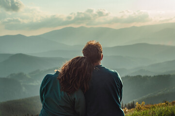 Leinwandbilder Olivgrün landscape in the mountain couple a man and a woman sit together bowing their heads on their shoulders and looking into the distance at a beautiful view, relationships outdoor recreation travel family  © Hordina Anastasia 