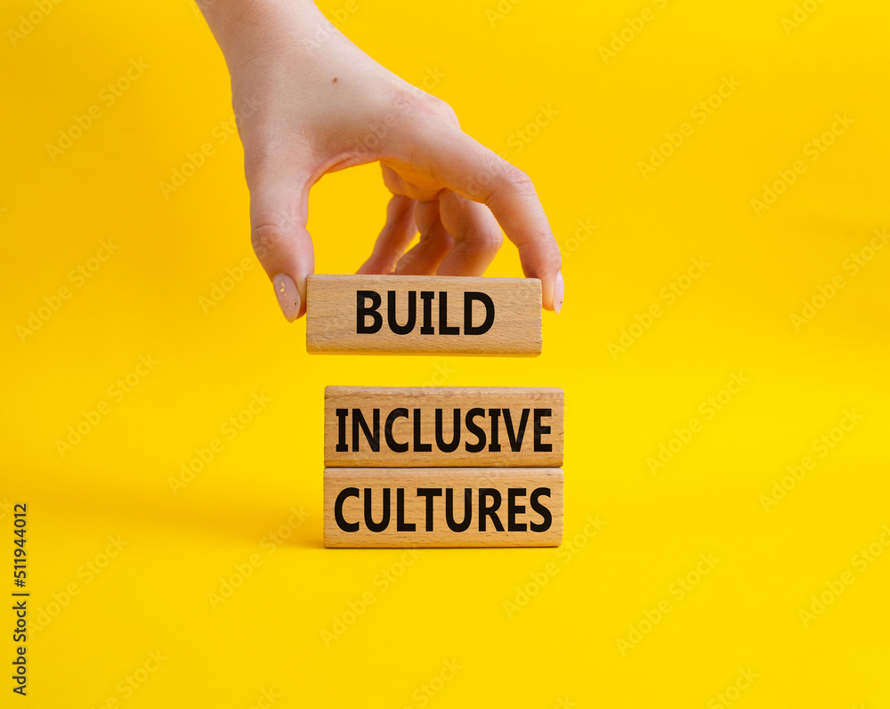 Build Inclusive Cultures symbol. Wooden blocks with words Build