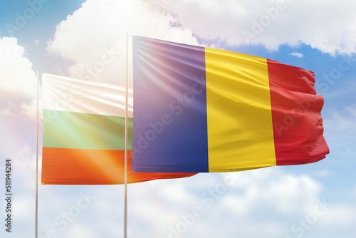 Sunny blue sky and flags of romania and bulgaria