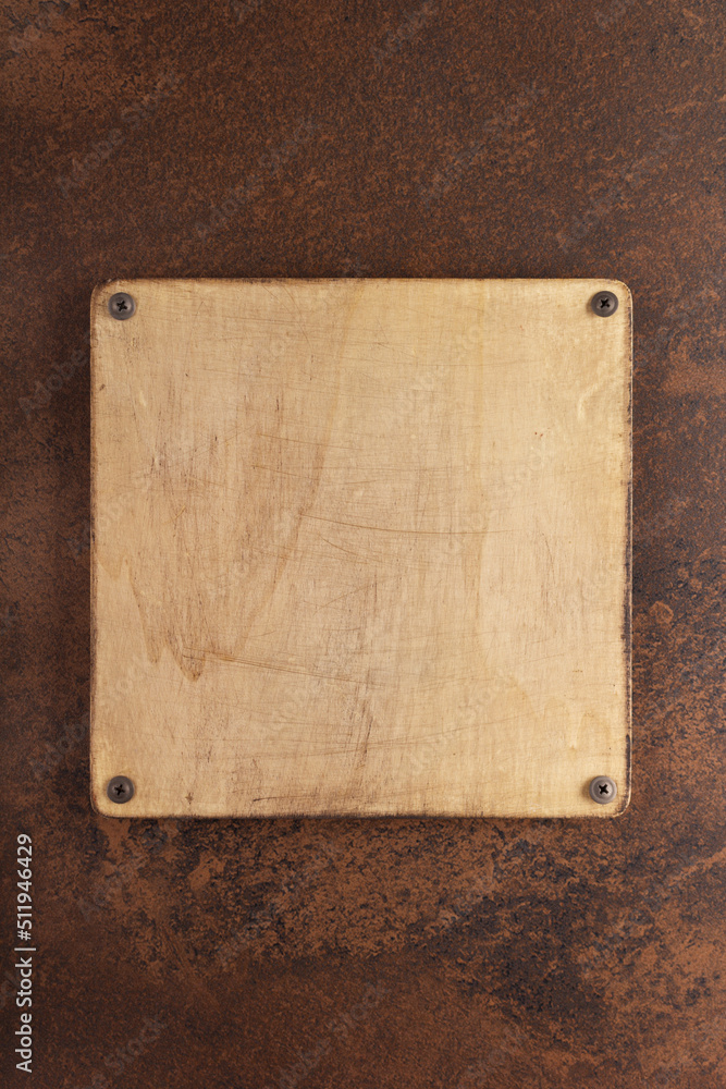 Wooden nameplate or sign board screwed at wall background. Front view of name plate Wooden nameplate or sign board screwed at wall background. Front view of name plate