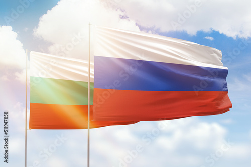 Sunny blue sky and flags of russia and bulgaria