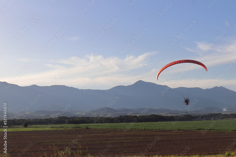 Paragliding sail against the background view of rice plantation in Brazil Paragliding sail against the background view of rice plantation in Brazil
