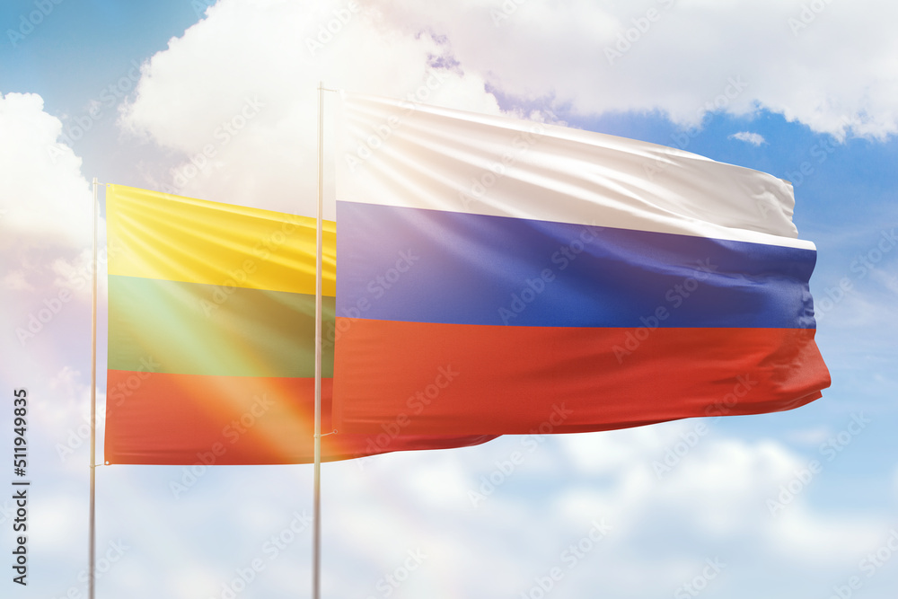 Sunny blue sky and flags of russia and lithuania Sunny blue sky and flags of russia and lithuania