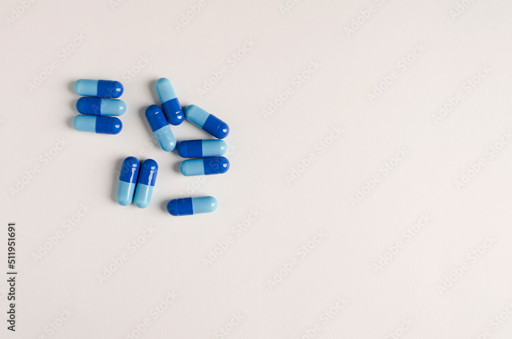 pills scattered on a white background