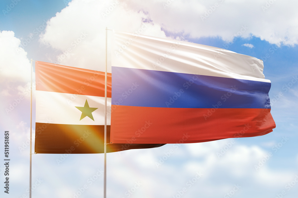 Sunny blue sky and flags of russia and syria Sunny blue sky and flags of russia and syria