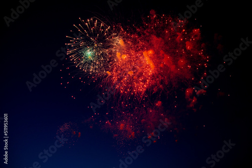 Red sparks, orange and smoke, fireworks of different colors on the background of the night sky. High quality photo