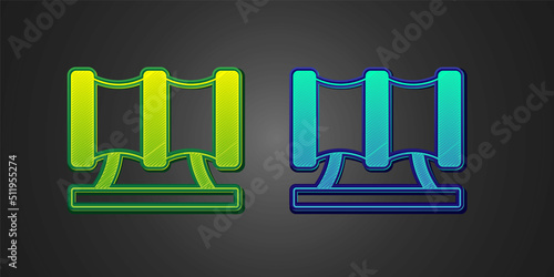 Green and blue Kid playground slide pipe icon isolated on black background. Vector