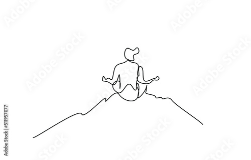 back view of a young man doing meditation yoga outdoors in nature
