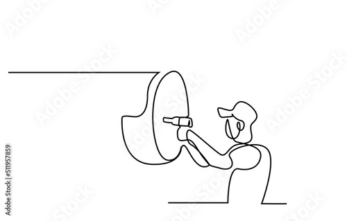 A car service worker is repairing the car. an employee adjusting the wheels of the car