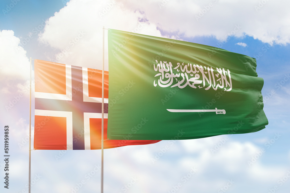 Obraz premium Sunny blue sky and flags of saudi arabia and norway
