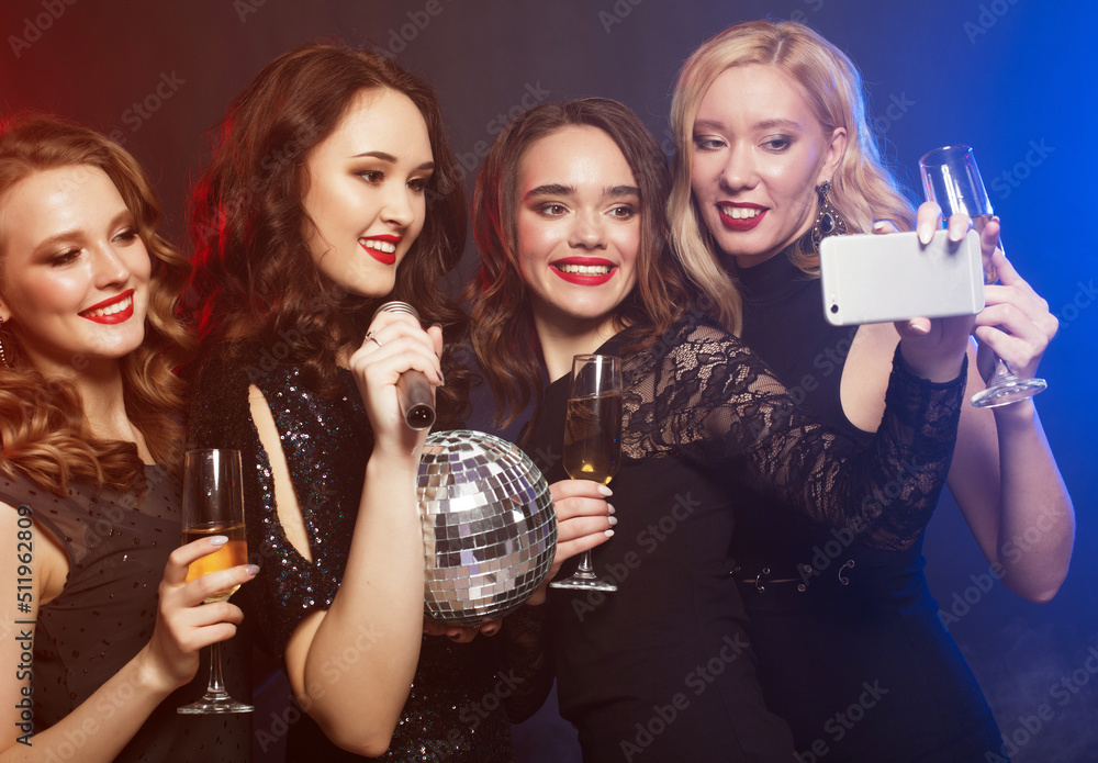 Group of partying women clinking flutes with sparkling wine and make selfie. Group of partying women clinking flutes with sparkling wine and make selfie.