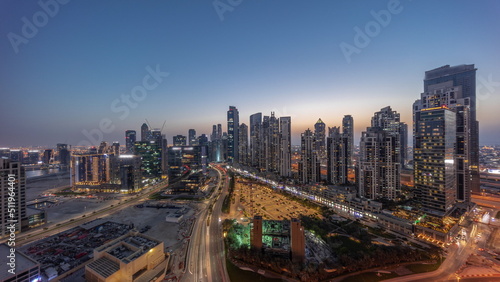 Panorama of Bay Avenue with modern towers residential development in Business Bay aerial day to night timelapse, Dubai © neiezhmakov
