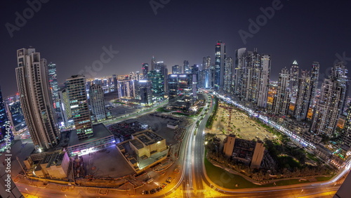 Panorama of Bay Avenue with modern towers residential development in Business Bay aerial night timelapse, Dubai