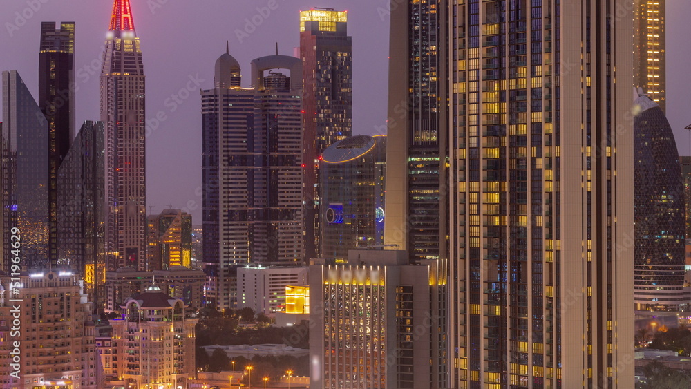 Row of the tall buildings around Sheikh Zayed Road and DIFC district aerial day to night timelapse in Dubai Row of the tall buildings around Sheikh Zayed Road and DIFC district aerial day to night timelapse in Dubai