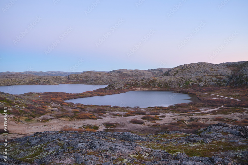 Lake in Teriberka in autumn. Colorful tundra landscape on the Kola Peninsula in autumn