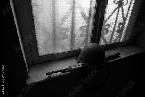 Conceptual photo of war between Russia and Ukraine. Ukraine and Russia flags on windowsill at night. Old creepy room with window. © zef art