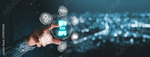 Plakat w ramie DevOps concept, Man hand touching DevOps icon on VR screen with blue bokeh background, Methodology development operations agil programming technology.concept.