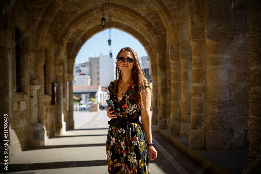 The beautiful girl in the medieval arch tunnel during vacation in Larnaca, Cyprus.