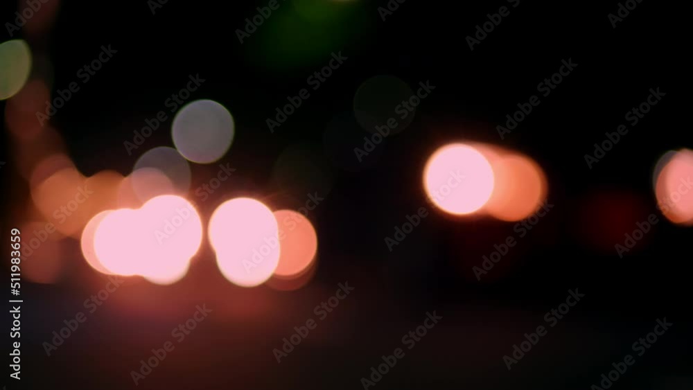 Bokeh light from headlight car at night time. Bokeh lights in the city night background. Night road lights blurred bokeh of cars in traffic on the road at night. Bokeh light from headlight car at night time. Bokeh lights in the city night background. Night road lights blurred bokeh of cars in traffic on the road at night.