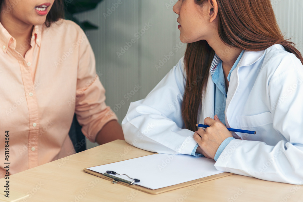Fototapeta premium Close up hands Woman doctor holding hands patient encourage cheer up consultation at hospital medicare clinic. Doctor talking to patient support giving hope mental health therapy consoling recovery