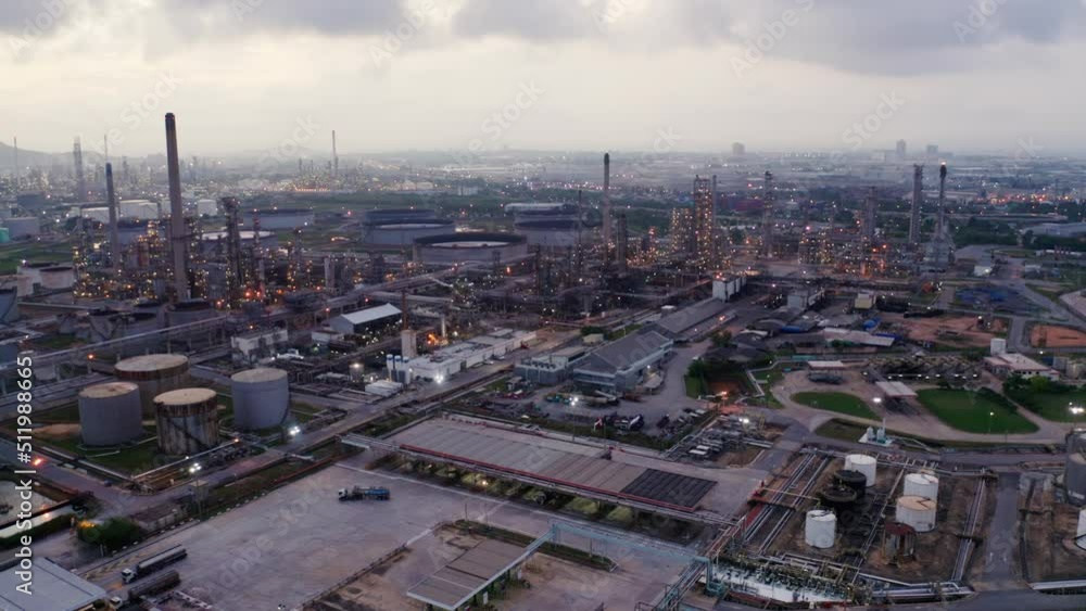 Aerial view drone flying with light oil terminal is industrial facility for storage of oil and petrochemical. oil manufacturing products. power electric plant. low light. Refinery b roll drone shot 4k Aerial view drone flying with light oil terminal is industrial facility for storage of oil and petrochemical. oil manufacturing products. power electric plant. low light. Refinery b roll drone shot 4k