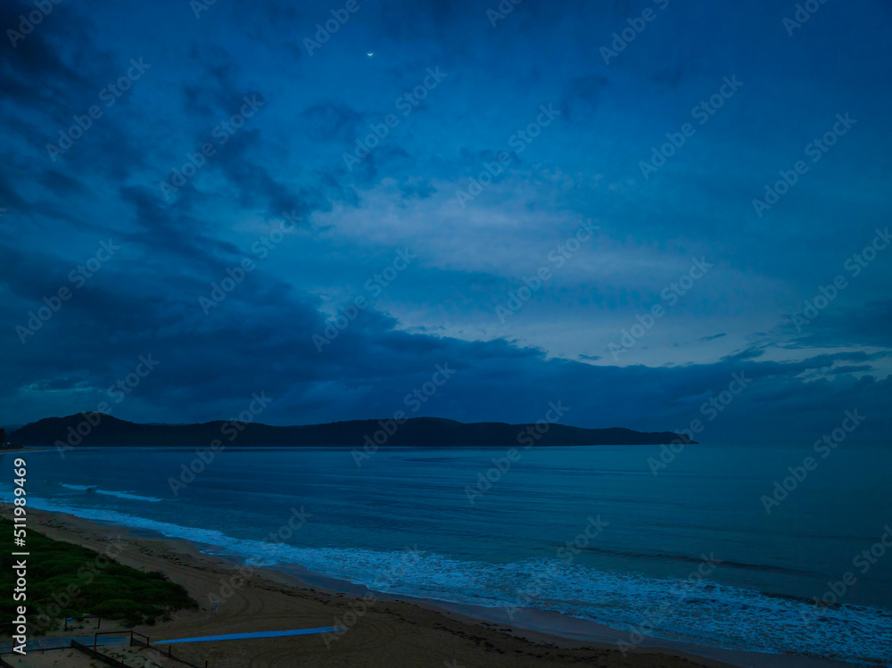Fototapeta premium Moody aerial sunrise seascape with rain clouds