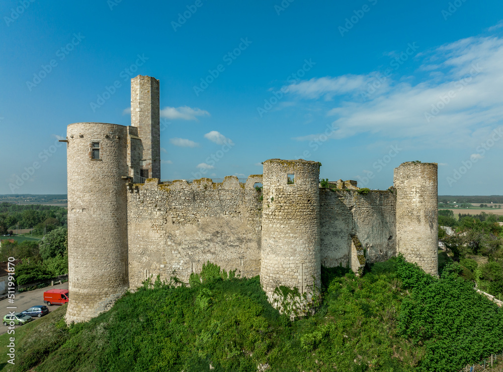 Aerial view of medieval ruined Gothic Billy castle in Allier central France with keep, five towers, fortified gatehouse, hexagonal shape watch tower, imposing chatelet guards the entrance