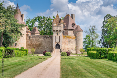 View of  Thoury castle in Saint-Pourain-sur-Besbre in Auvergne, feudal castle with fortified high curtain walls enclosing a courtyard, gate tower embellished with battlements and two towers 