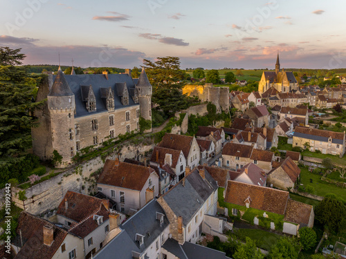 Aerial sunset view of Montresor medieval castle with a Renaissance mansion in Indre et Loire, on a rocky overhand dominating the valley, on of the most beautiful villages of France photo