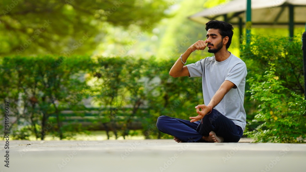 Fototapeta premium international yoga day image boy meditating in lotus position at park