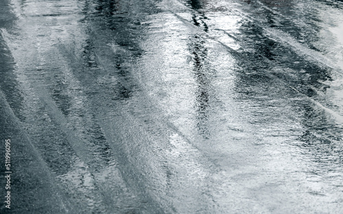wet asphalt road with reflection of trees after heavy rain